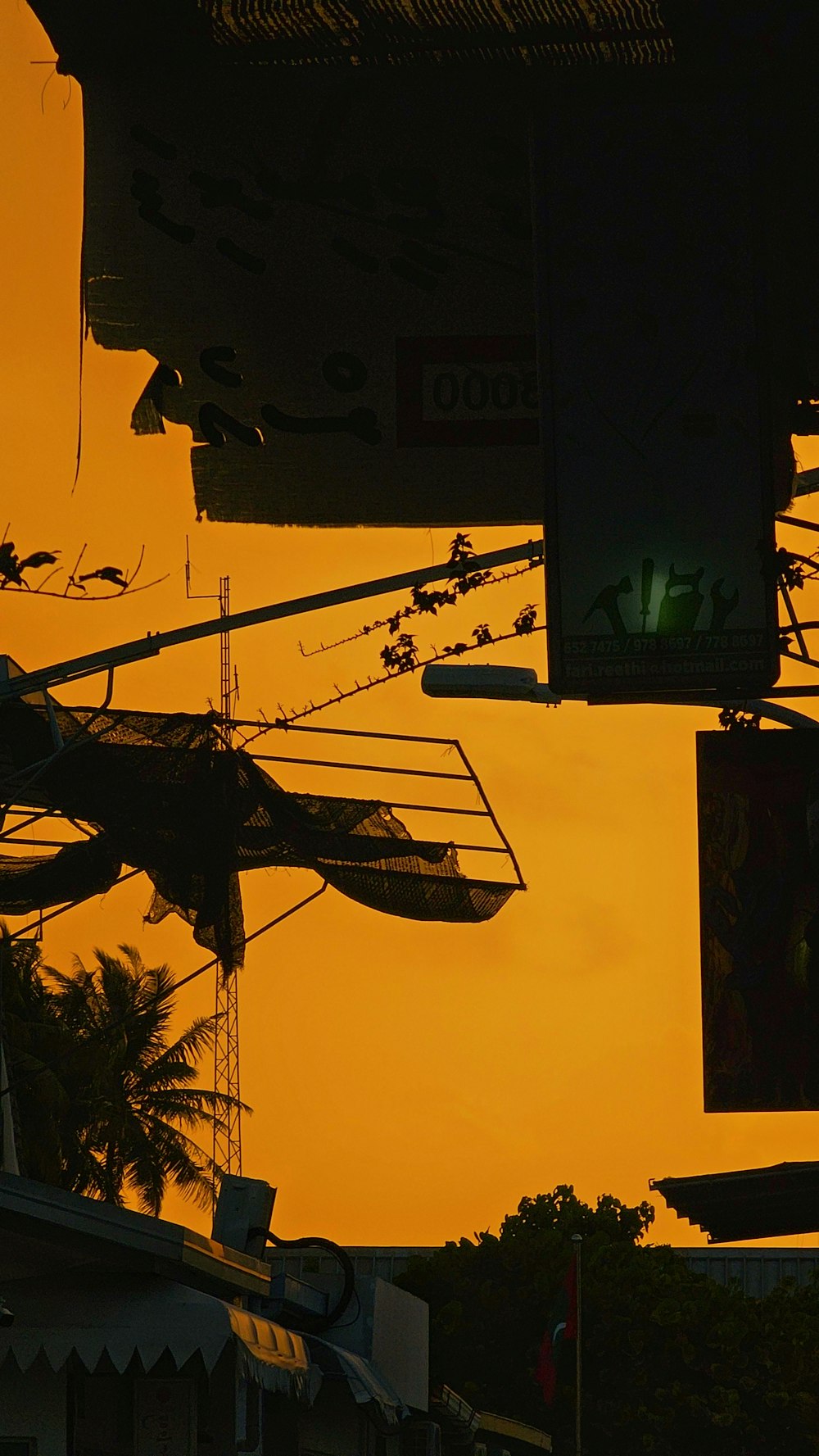 a view of a street sign with a yellow sky in the background