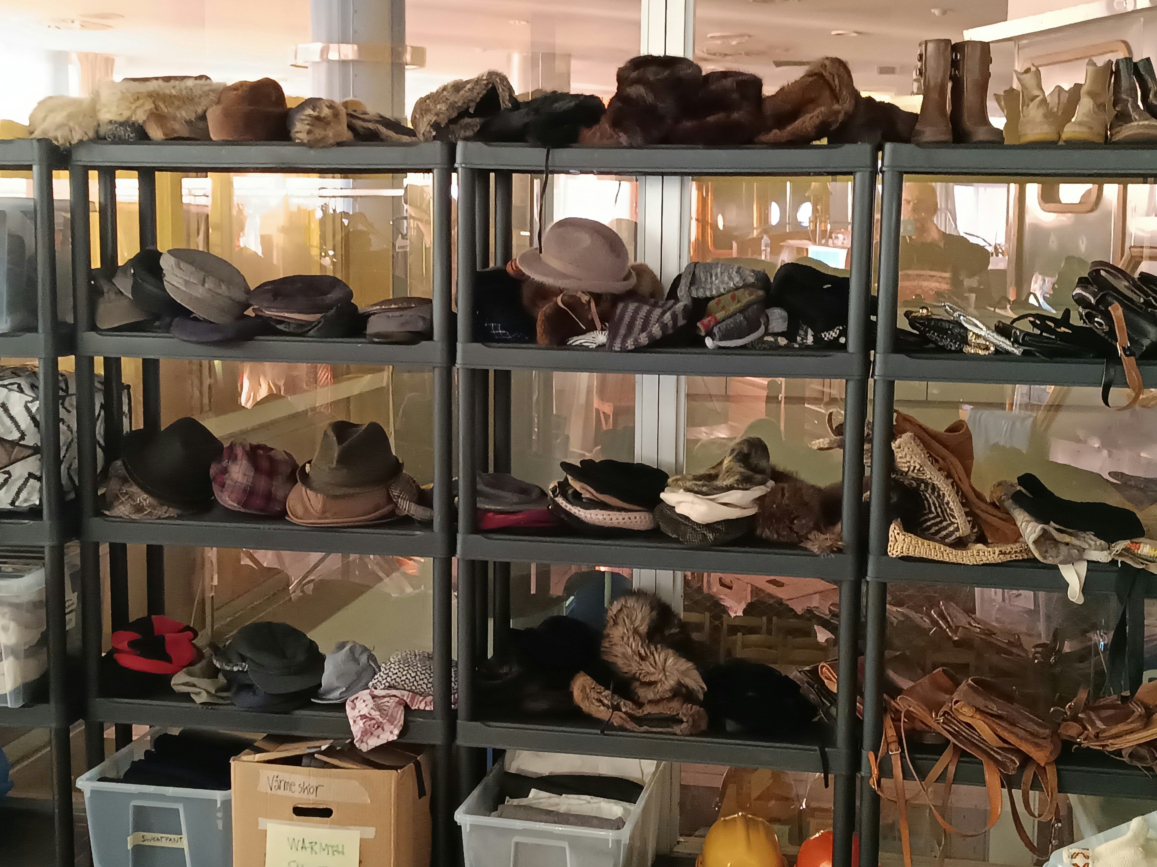 a shelf filled with lots of hats and shoes