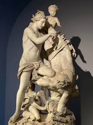 a statue of a man on a horse and a boy on a horse