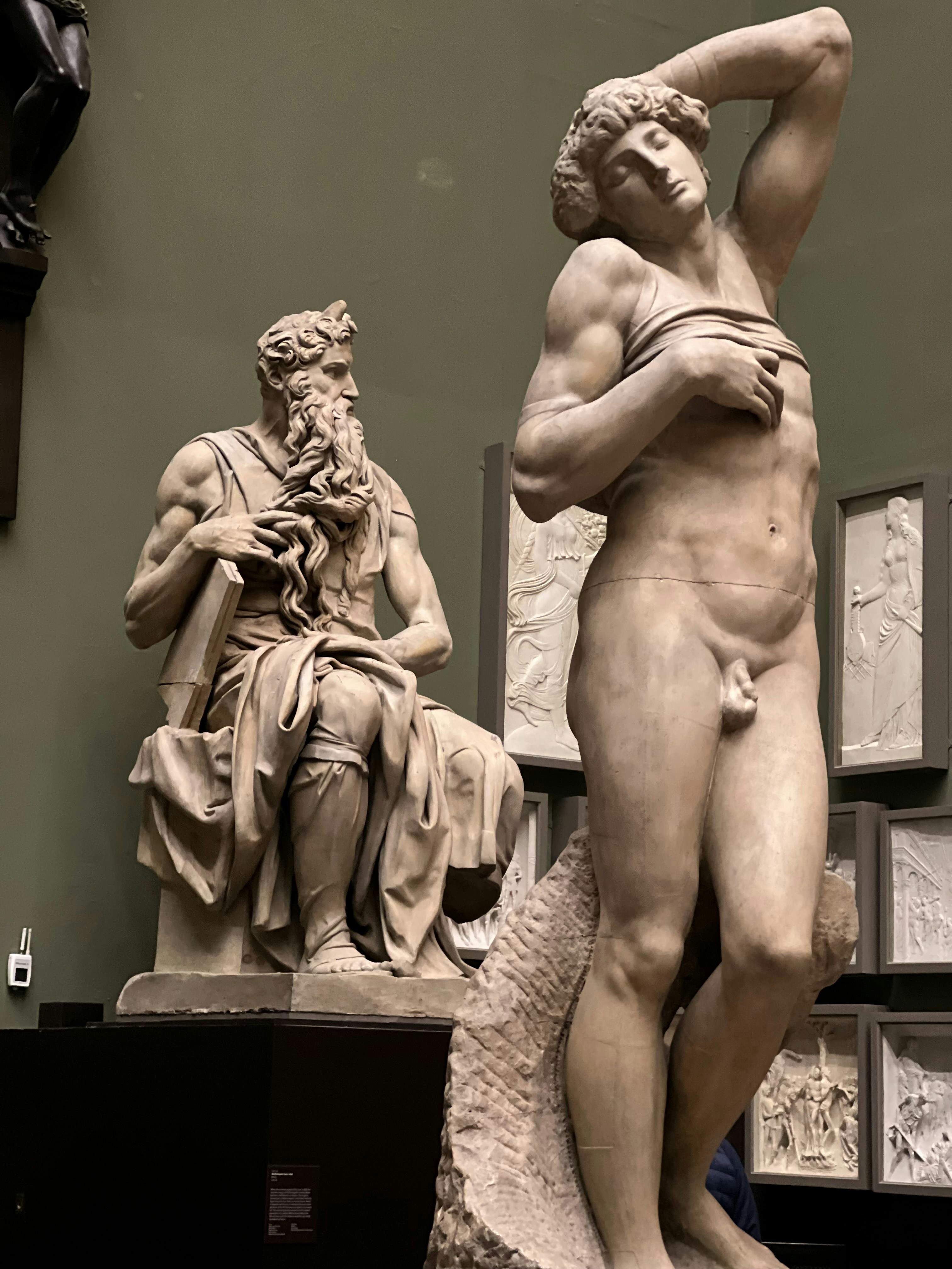a statue of a man standing next to a statue of a woman