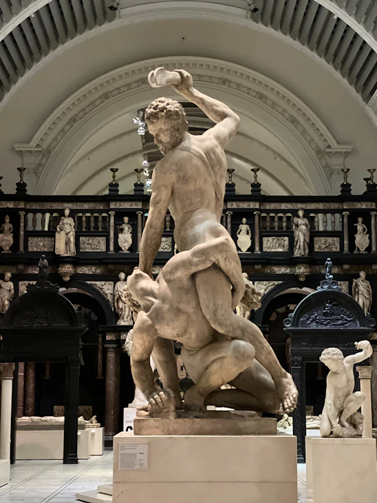 a statue of a man and a dog in a museum