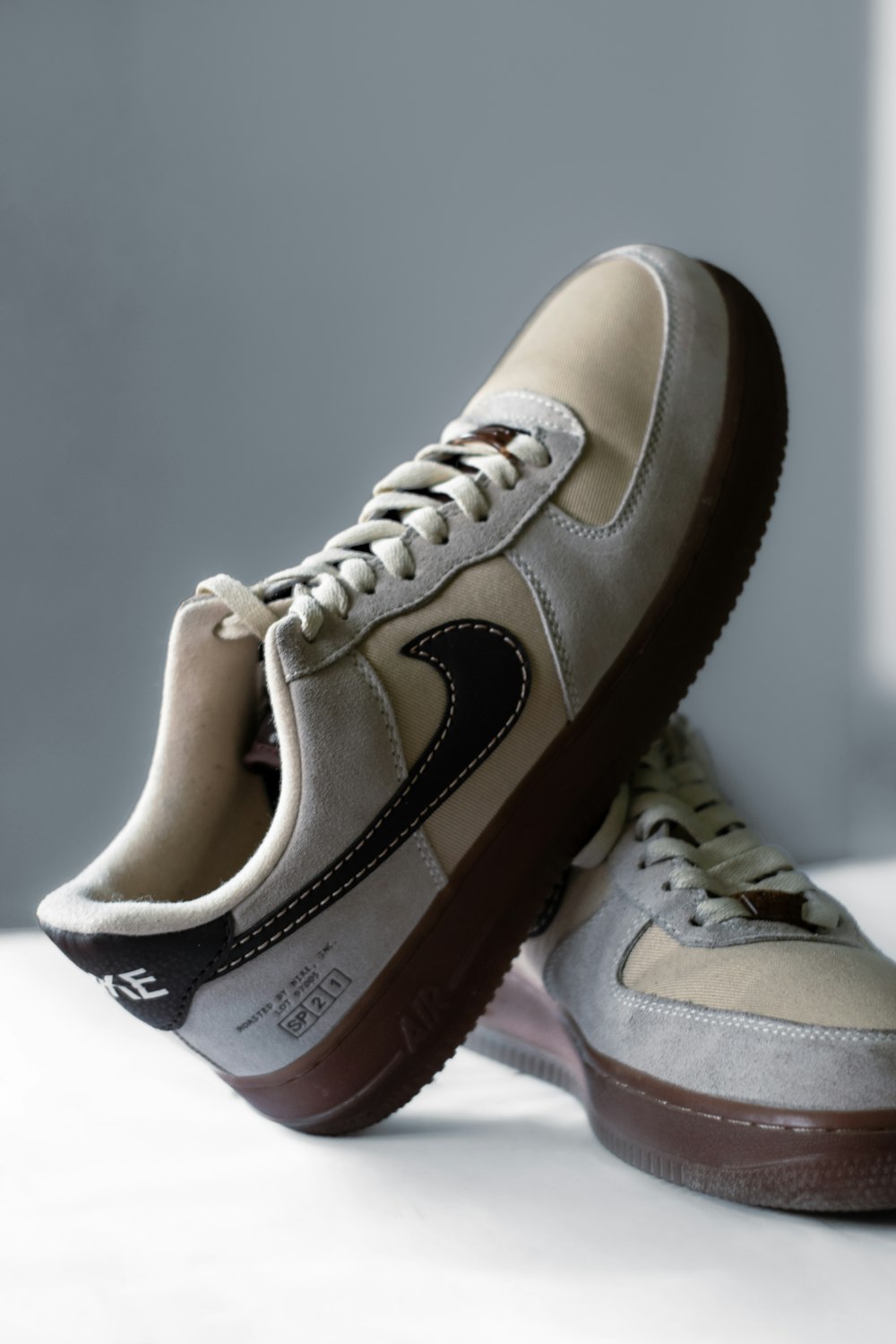 a pair of sneakers with a brown sole