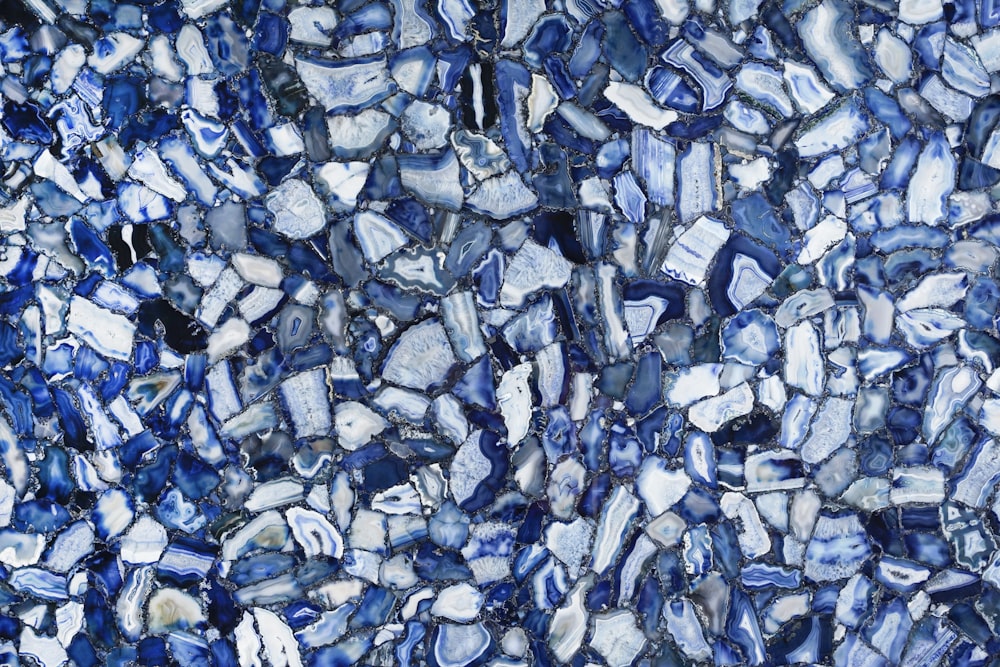 a close up of a blue and white mosaic tile