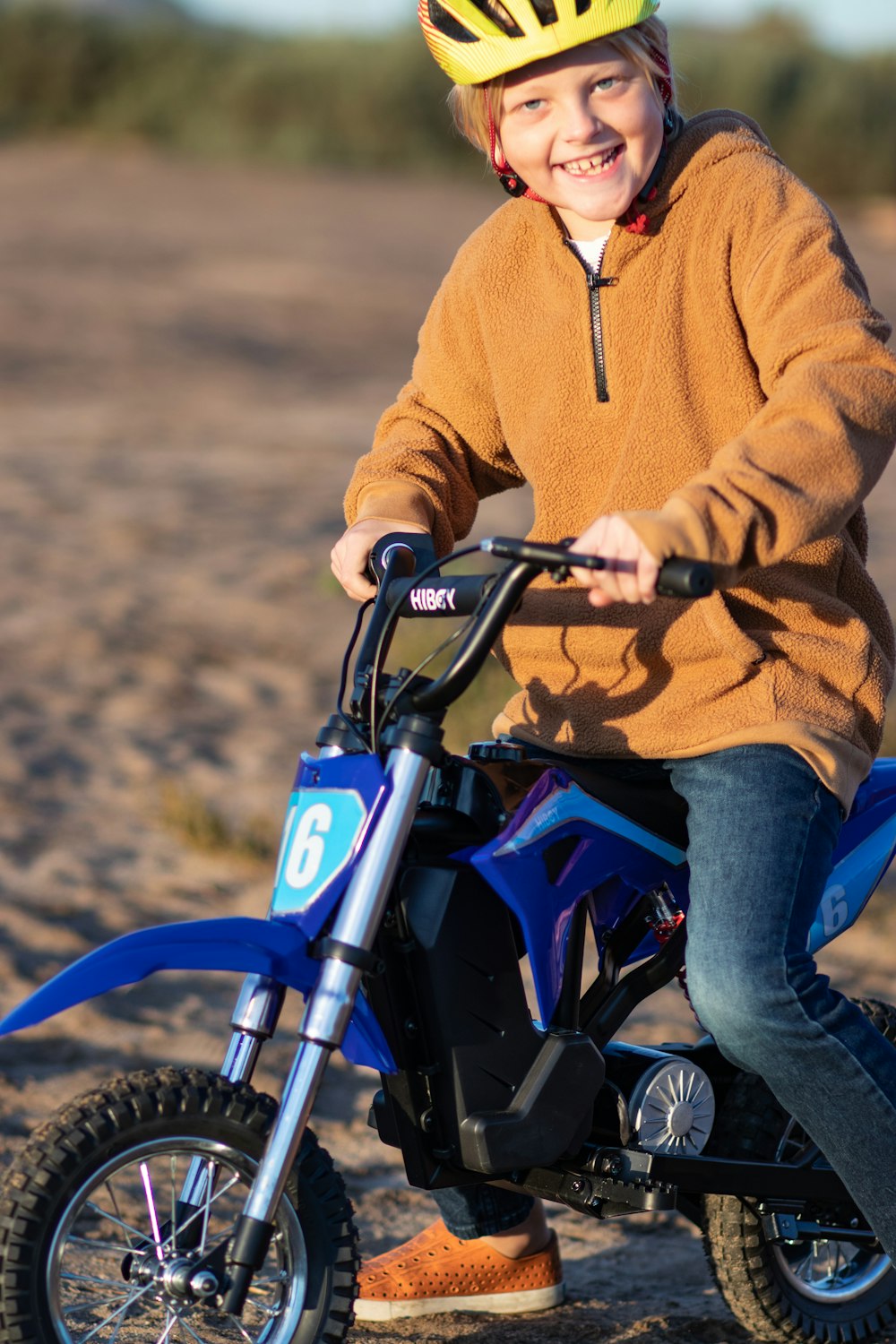 a young boy riding a small blue bike