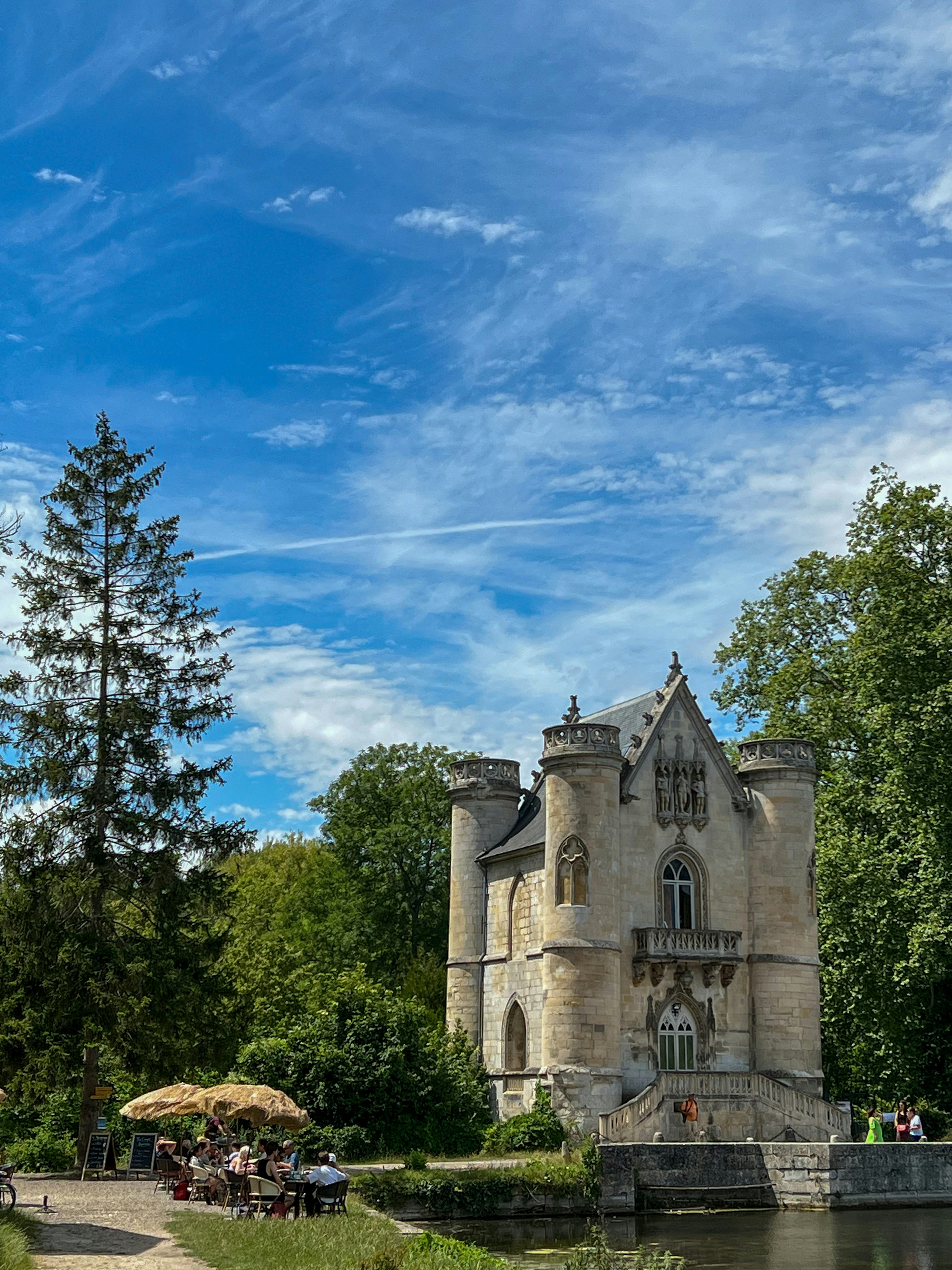 a castle like building sitting next to a body of water