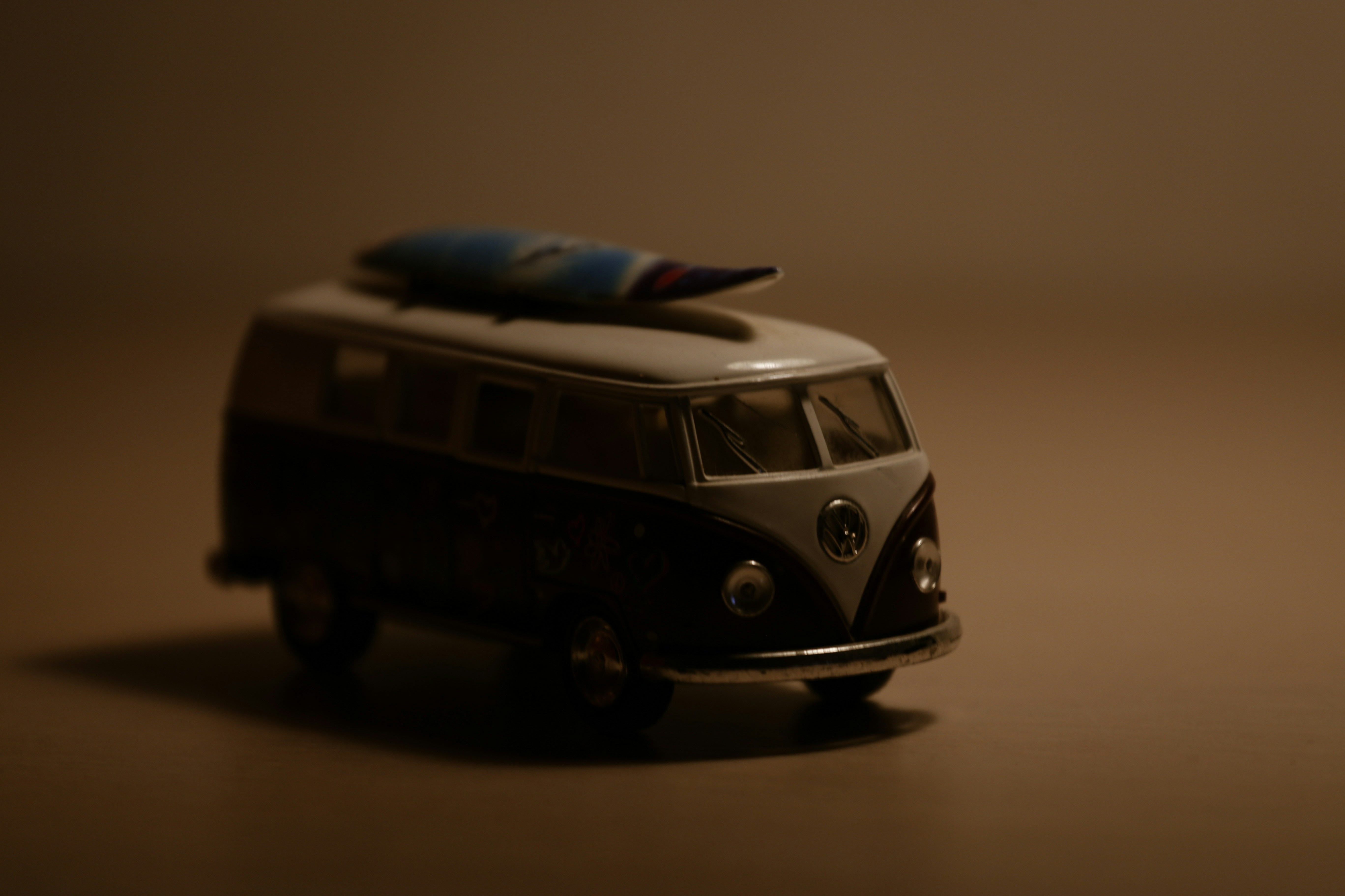 a toy van with a surfboard on top of it
