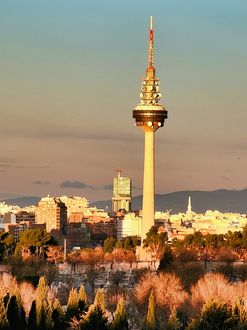 a tall tower with a sky scraper in the background