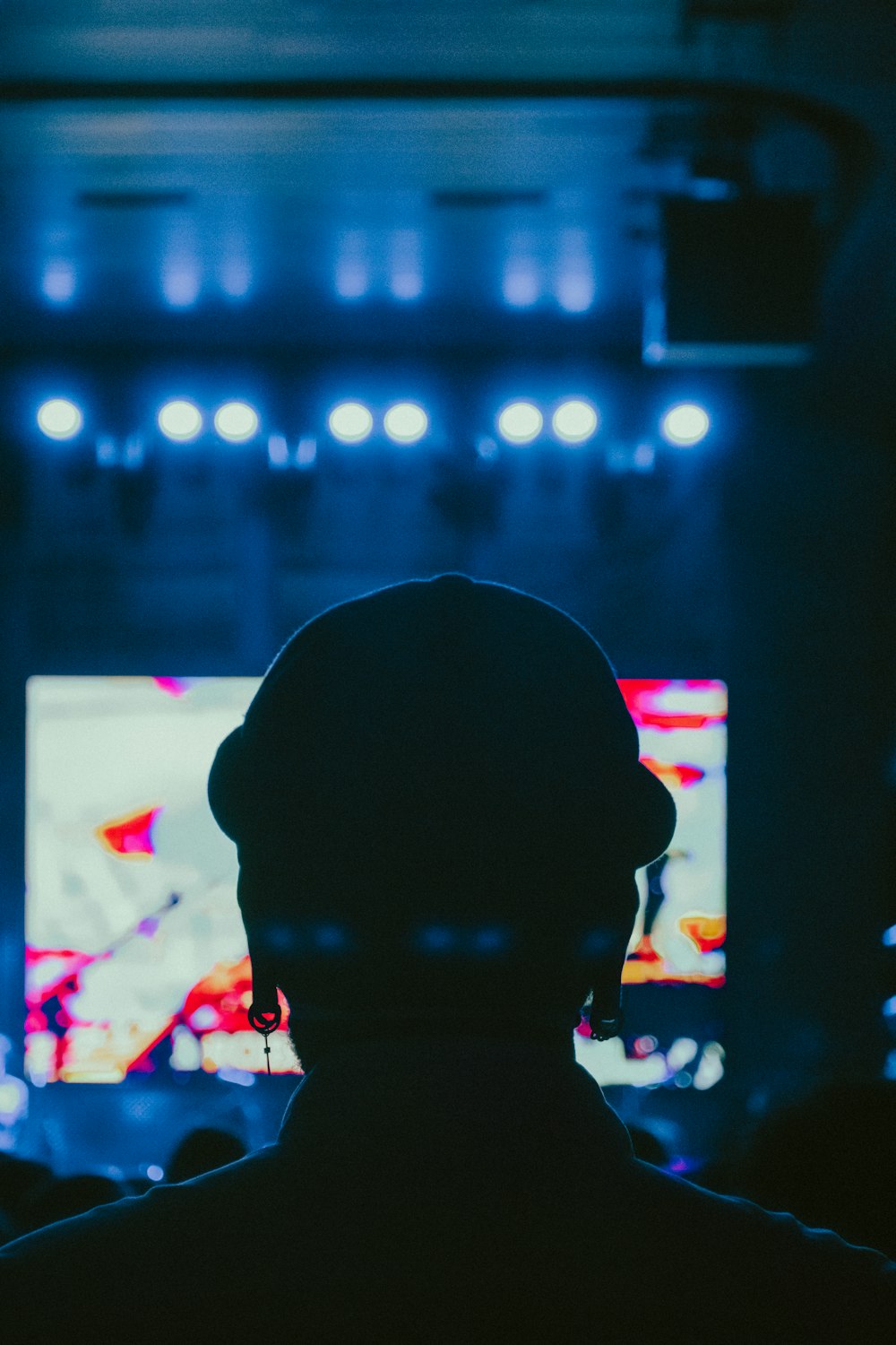 a person standing in front of a tv in a dark room