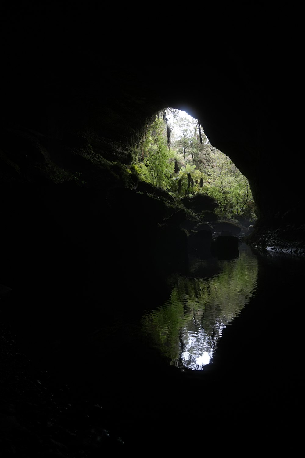 a dark cave with a light at the end of it