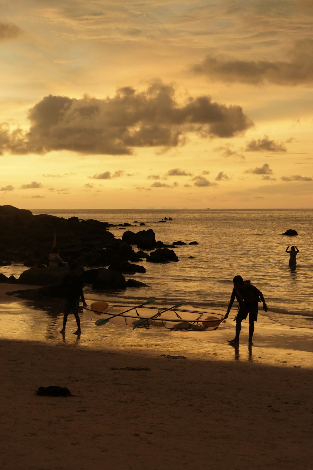 a couple of people standing on top of a beach