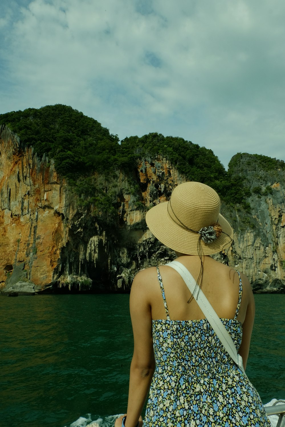 a woman sitting on a boat looking out at the water