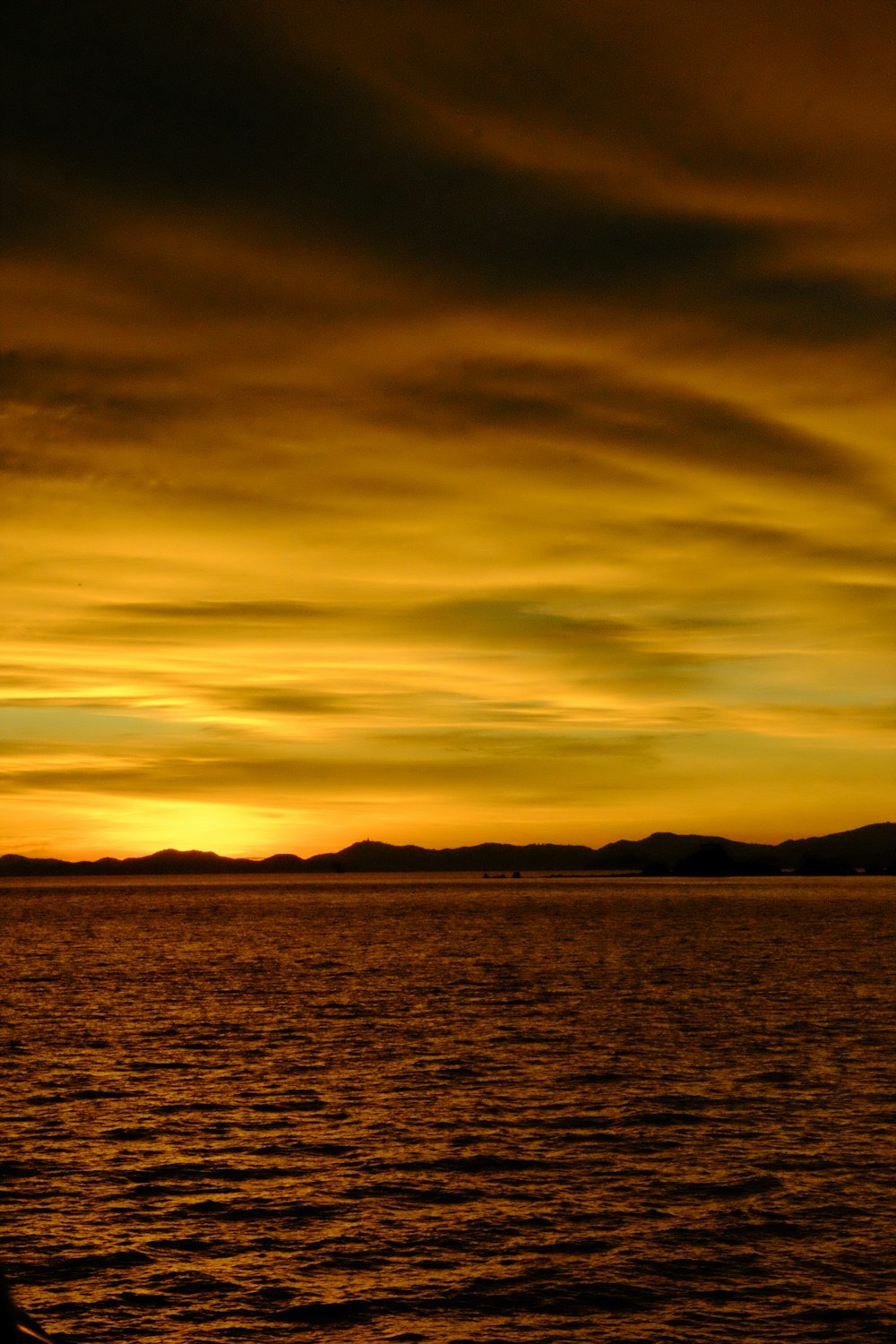 a person sitting on a boat watching the sunset