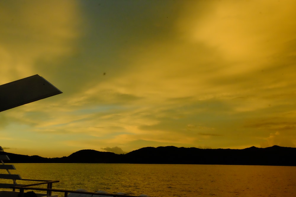 a boat traveling on a body of water at sunset