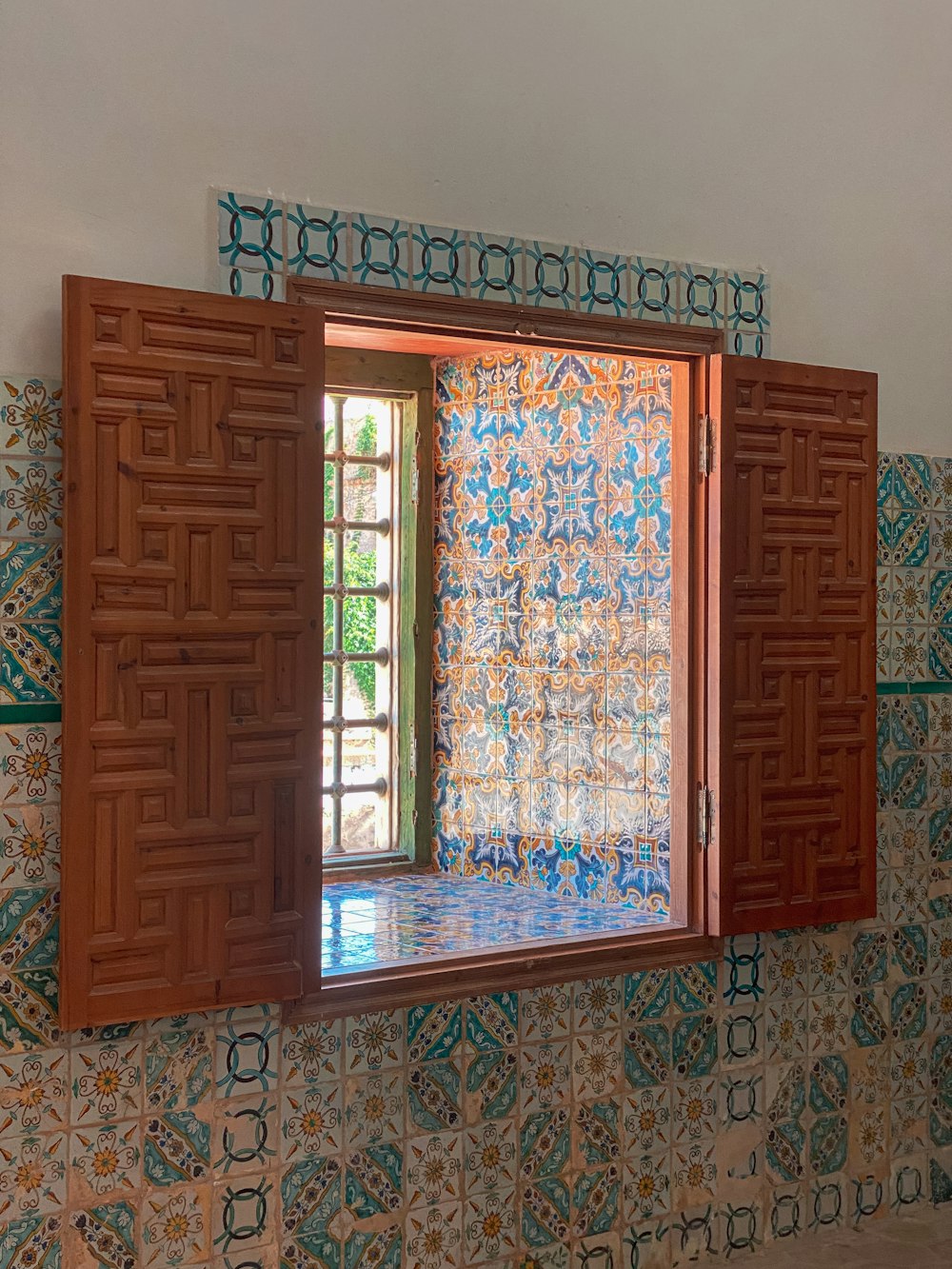 a bathroom with a window and a tiled wall