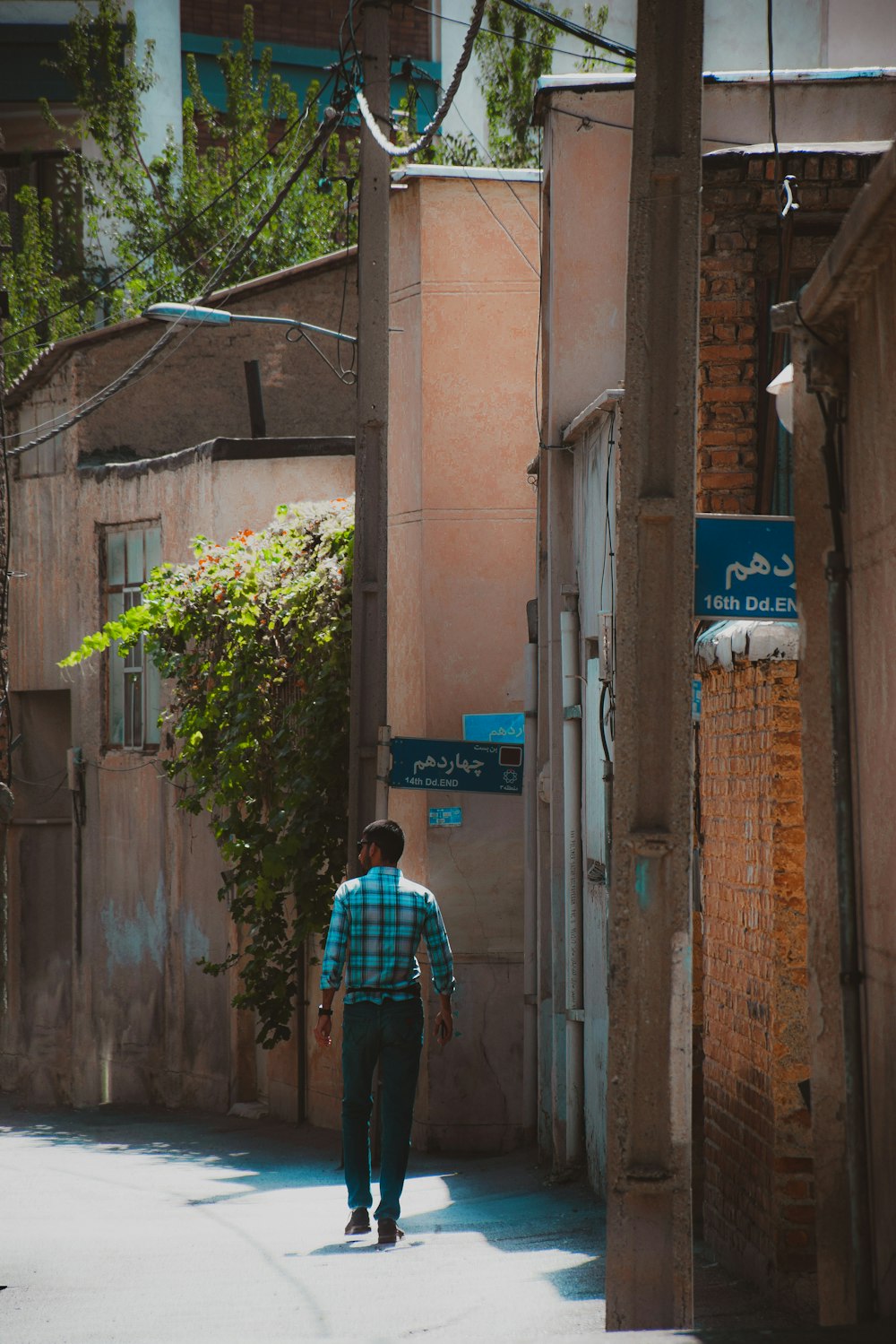 a man walking down a narrow alley way