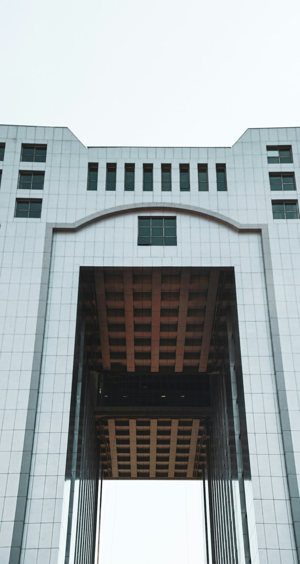 a tall white building with a sky background