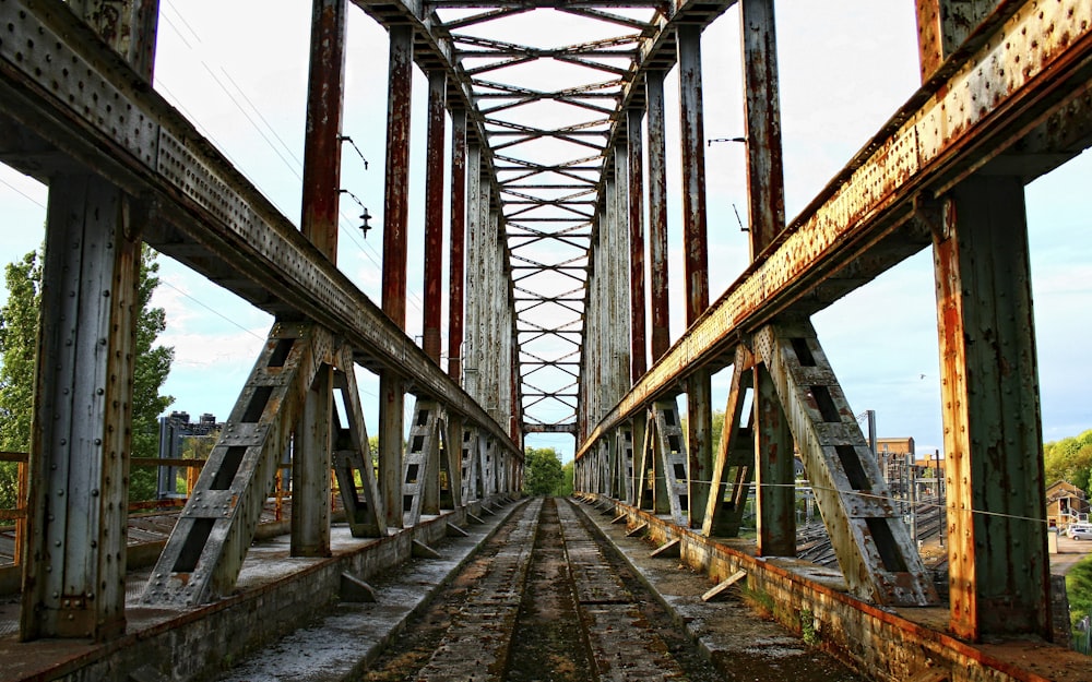 a view of a train track from the bottom of a bridge