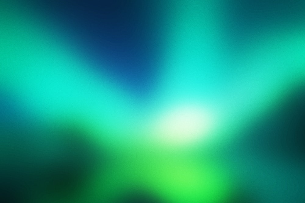 a blurry image of a green and blue background