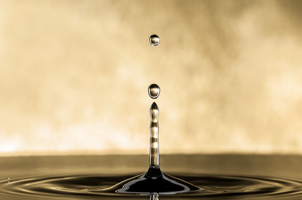 a drop of water falling into a body of water