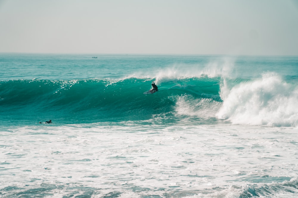 a person riding a surfboard on a wave in the ocean