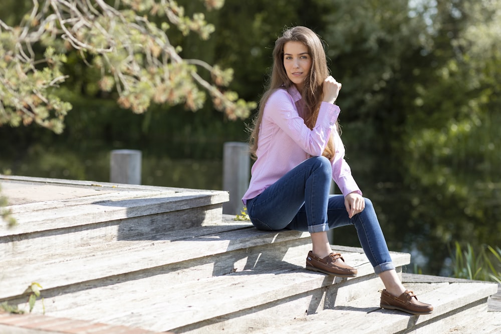 a woman is sitting on a set of stairs