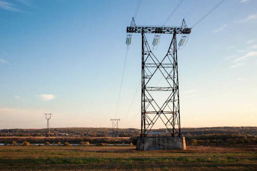 a tall metal tower sitting on top of a lush green field