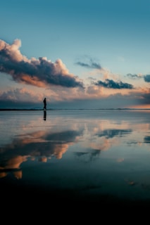 a person standing in the middle of a large body of water