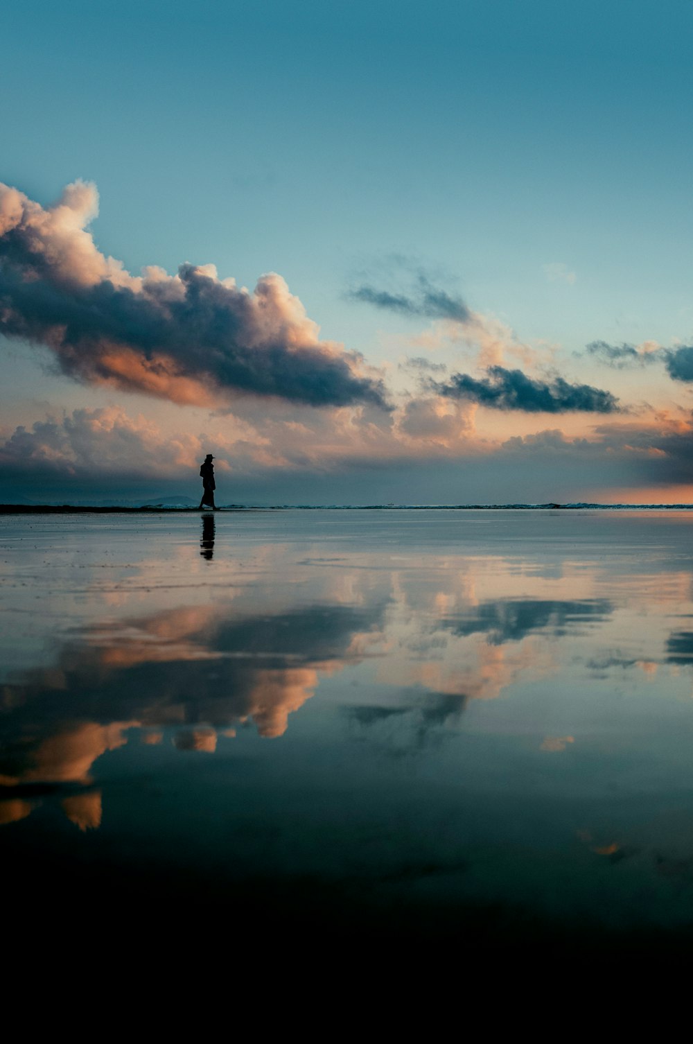 a person standing in the middle of a large body of water