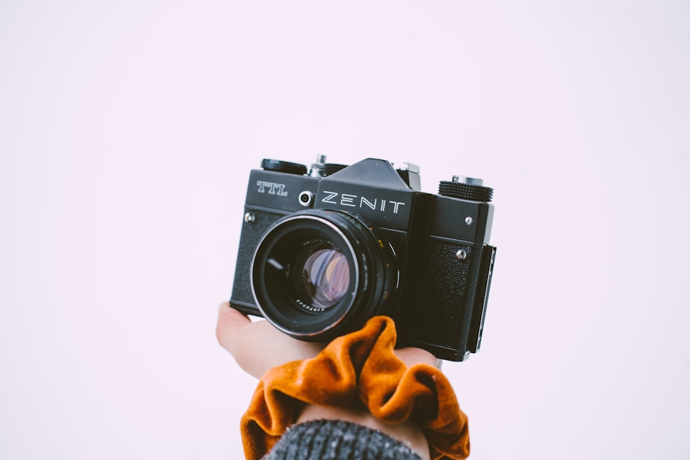 a person holding a camera in their hand