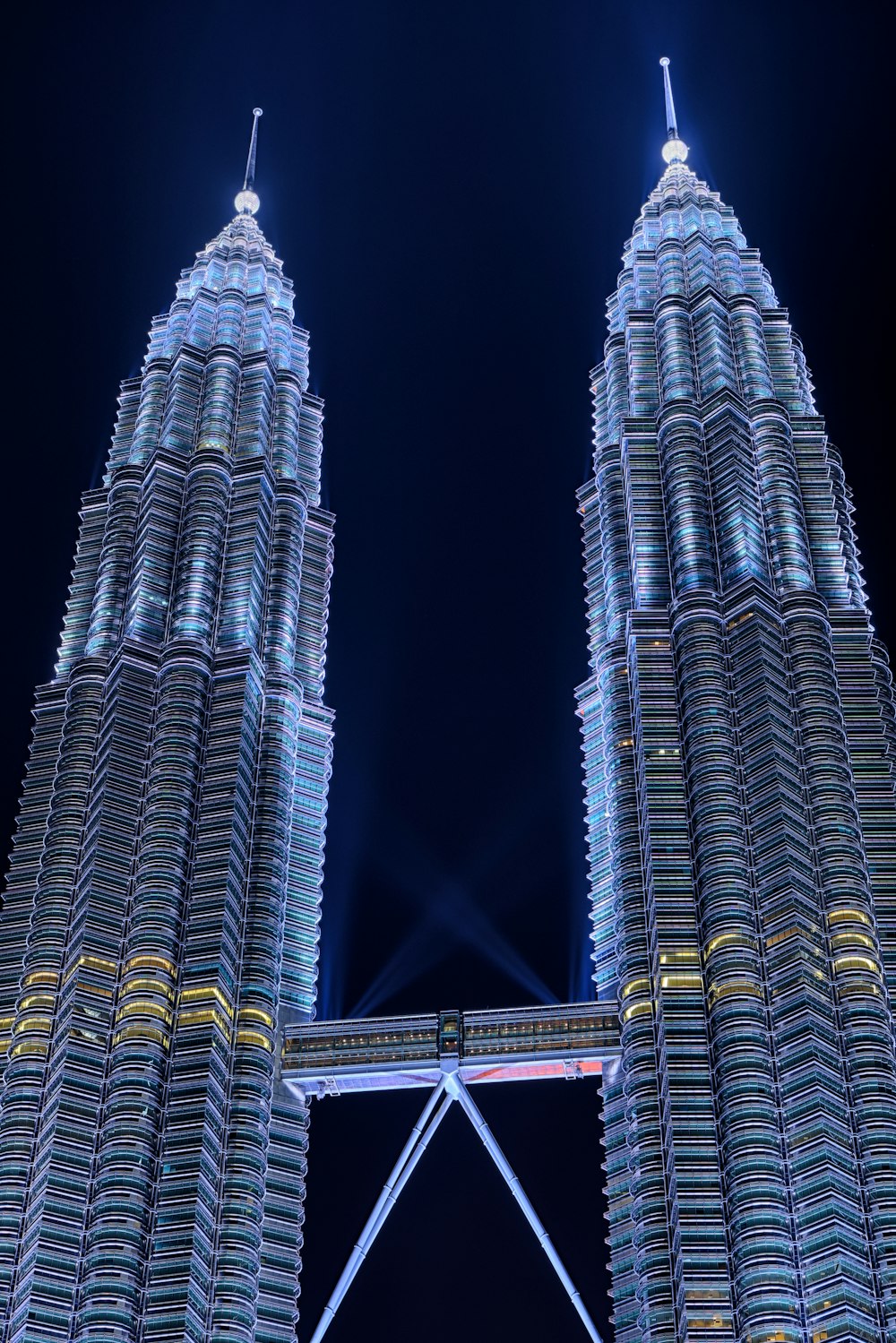 two tall buildings lit up at night time