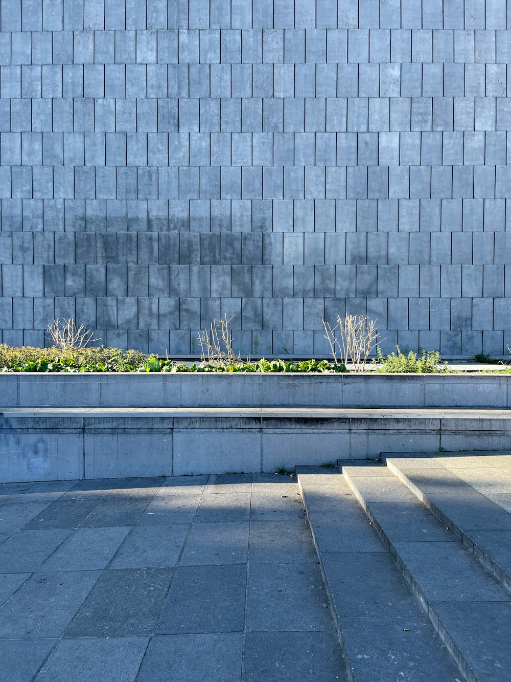 a person sitting on a bench in front of a building