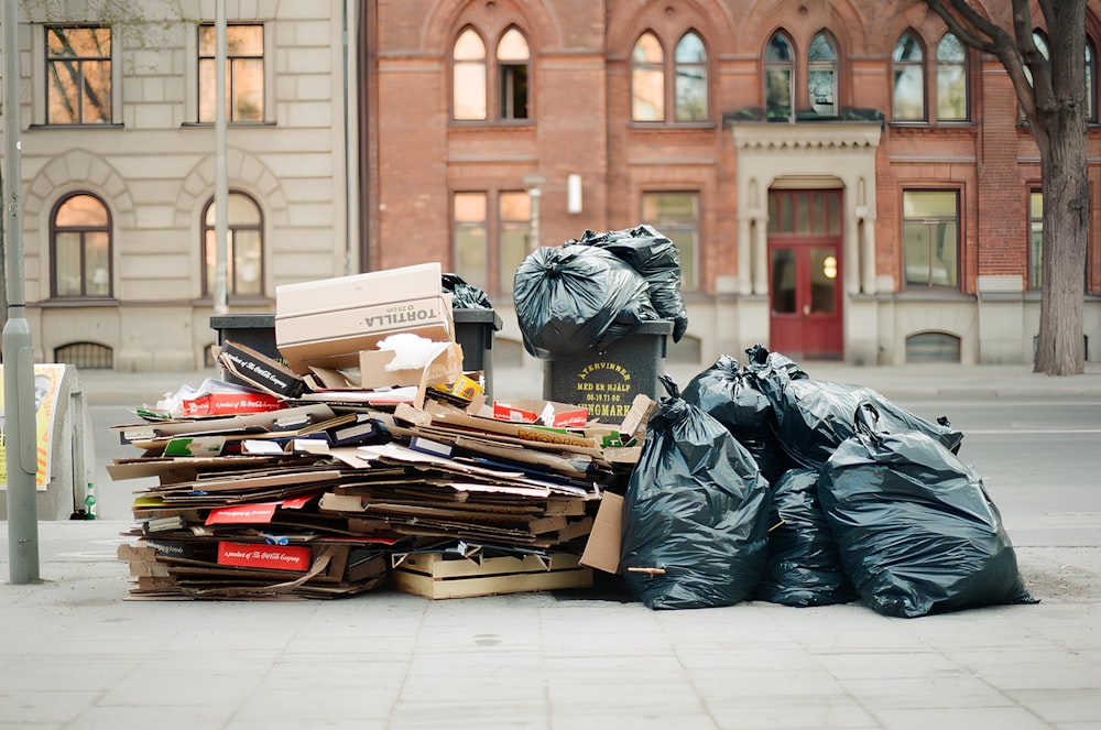 a pile of garbage sitting on the side of a road