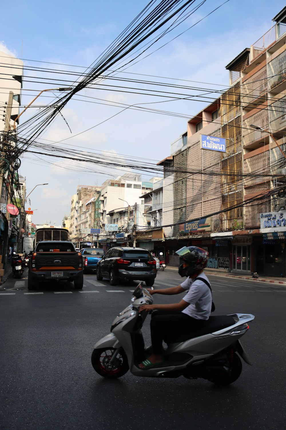 a person riding a scooter on a city street