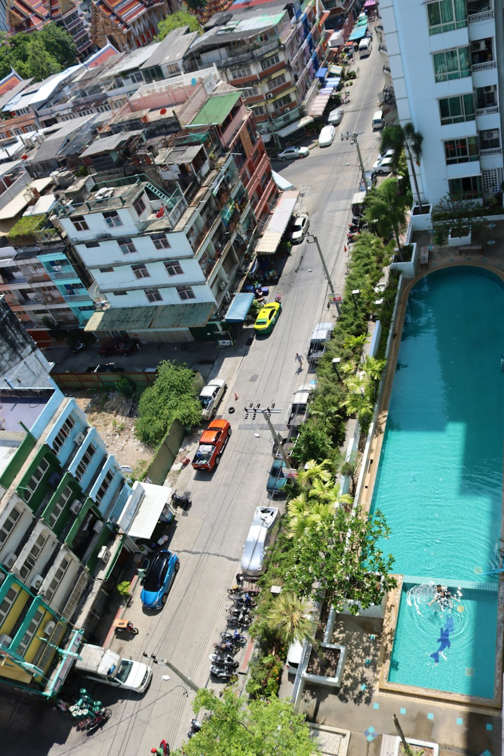 an aerial view of a city with a swimming pool