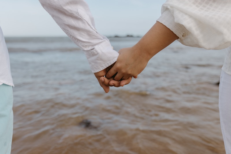 International couple holding hands close-up