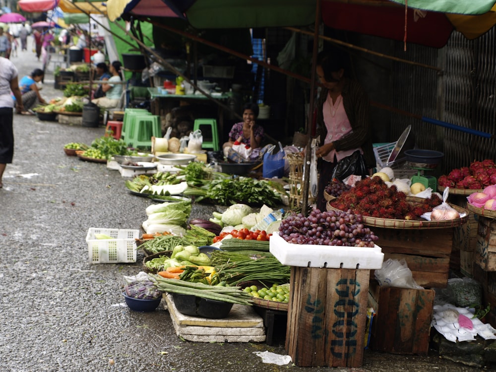 a bunch of fruits and vegetables on a street