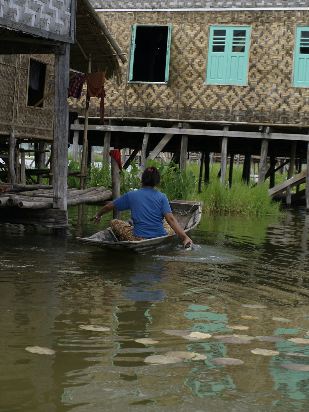 a person in a small boat on a body of water