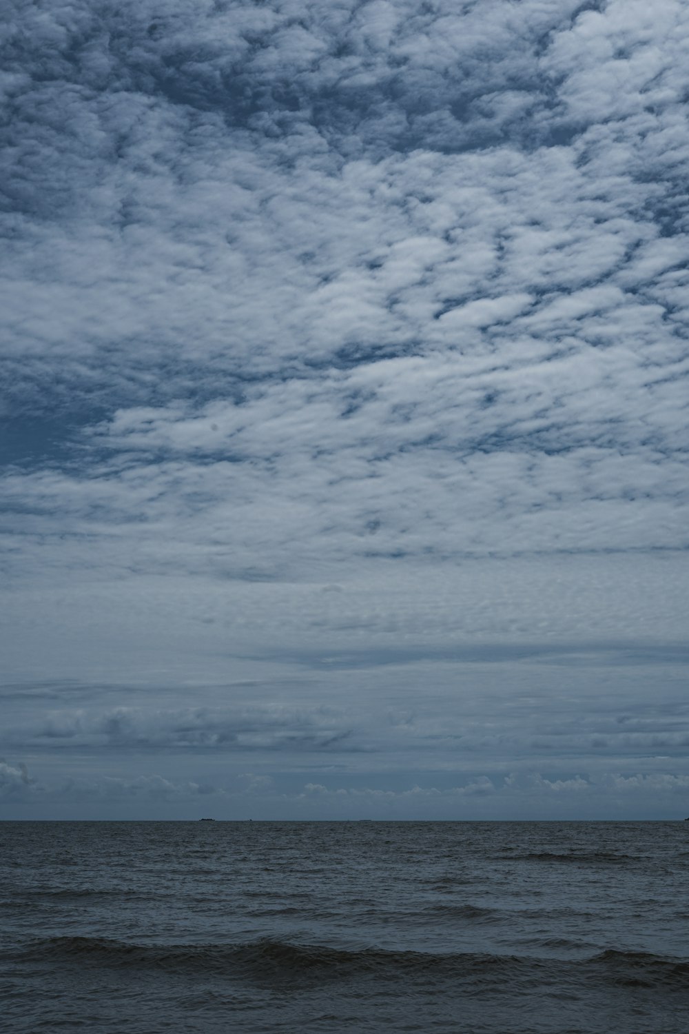 a large body of water under a cloudy sky