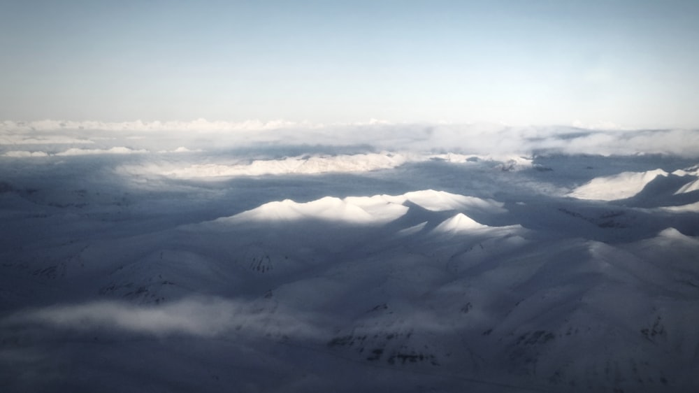 a view of a snowy mountain range from an airplane