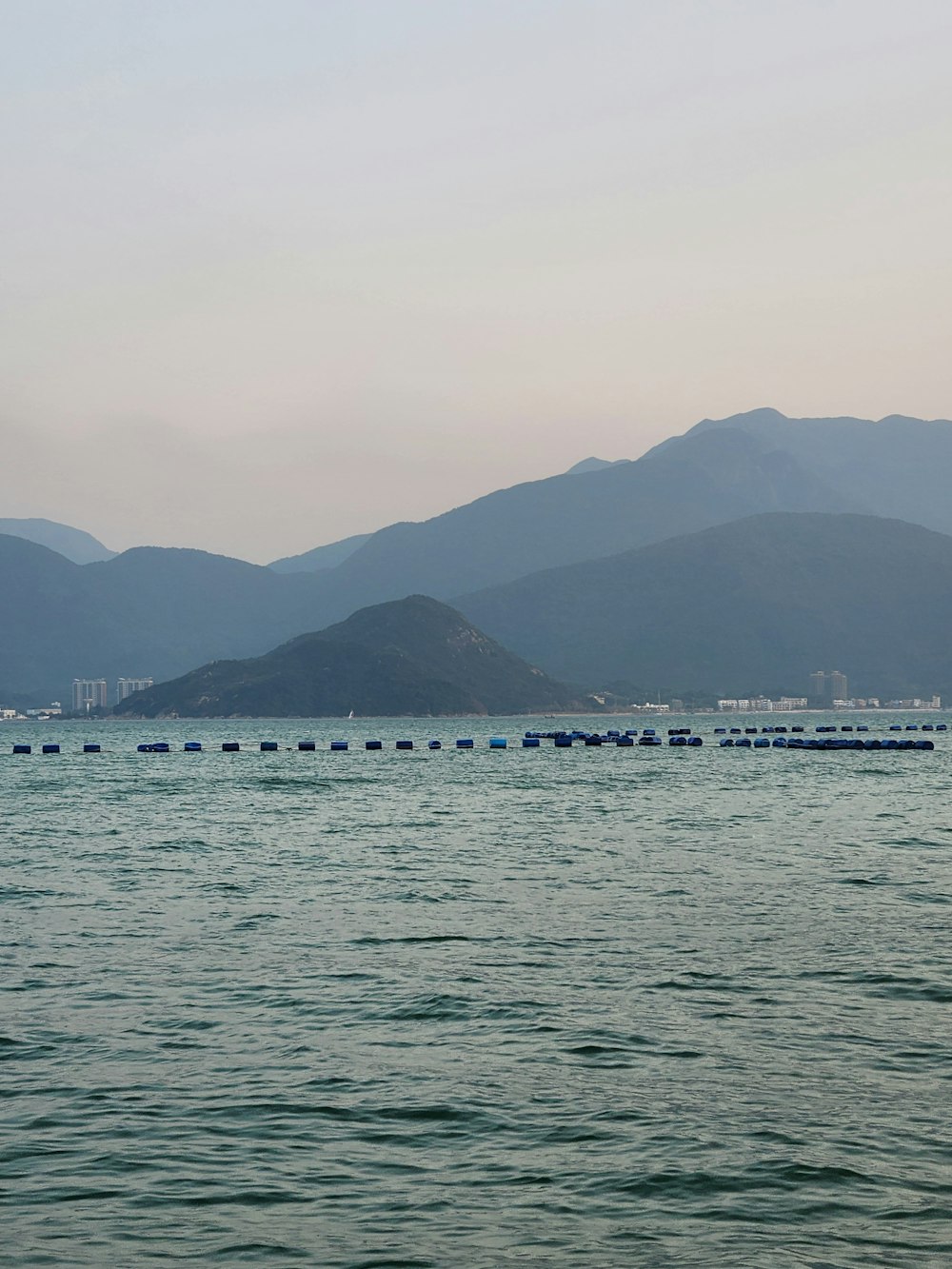 a large body of water with mountains in the background