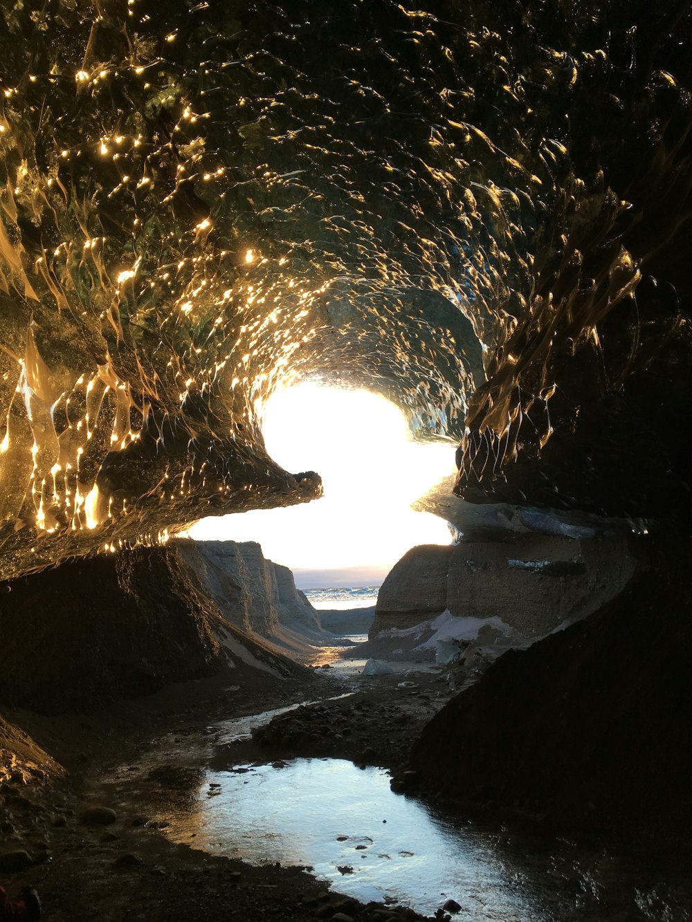 a light shines in the middle of a tunnel