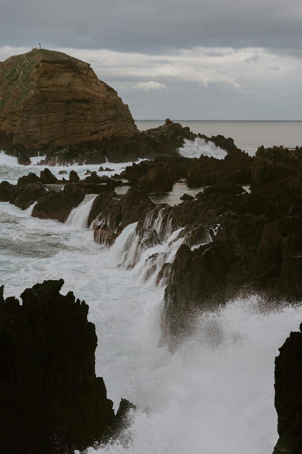 a large body of water near a rocky shore