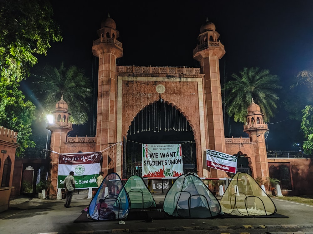 a group of tents set up in front of a gate