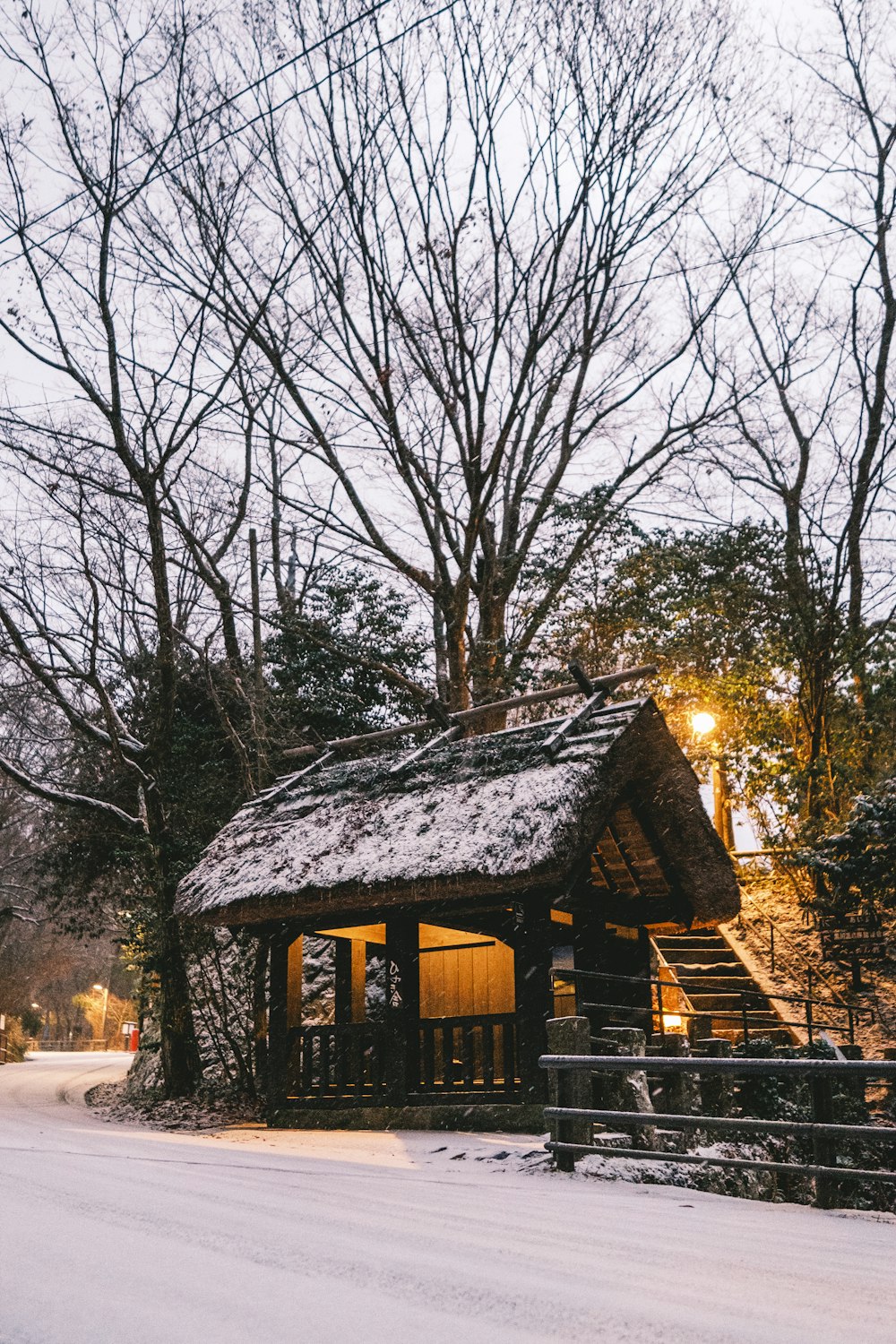 a small cabin in the middle of a snowy forest