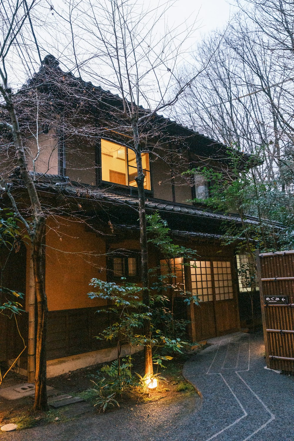 a house with a lit up lantern in front of it