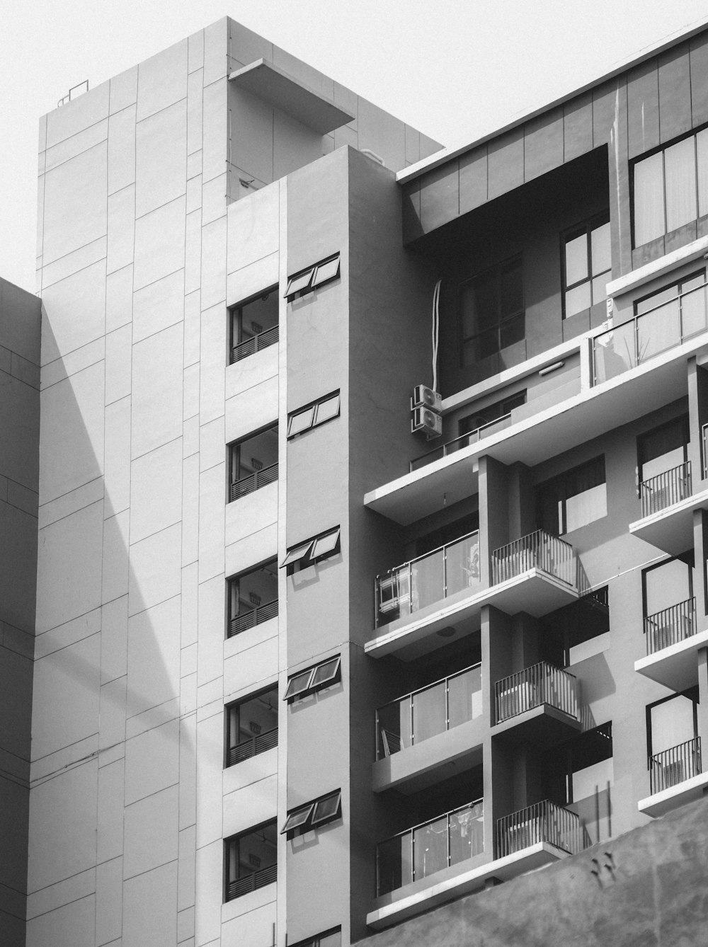 a black and white photo of a building with balconies