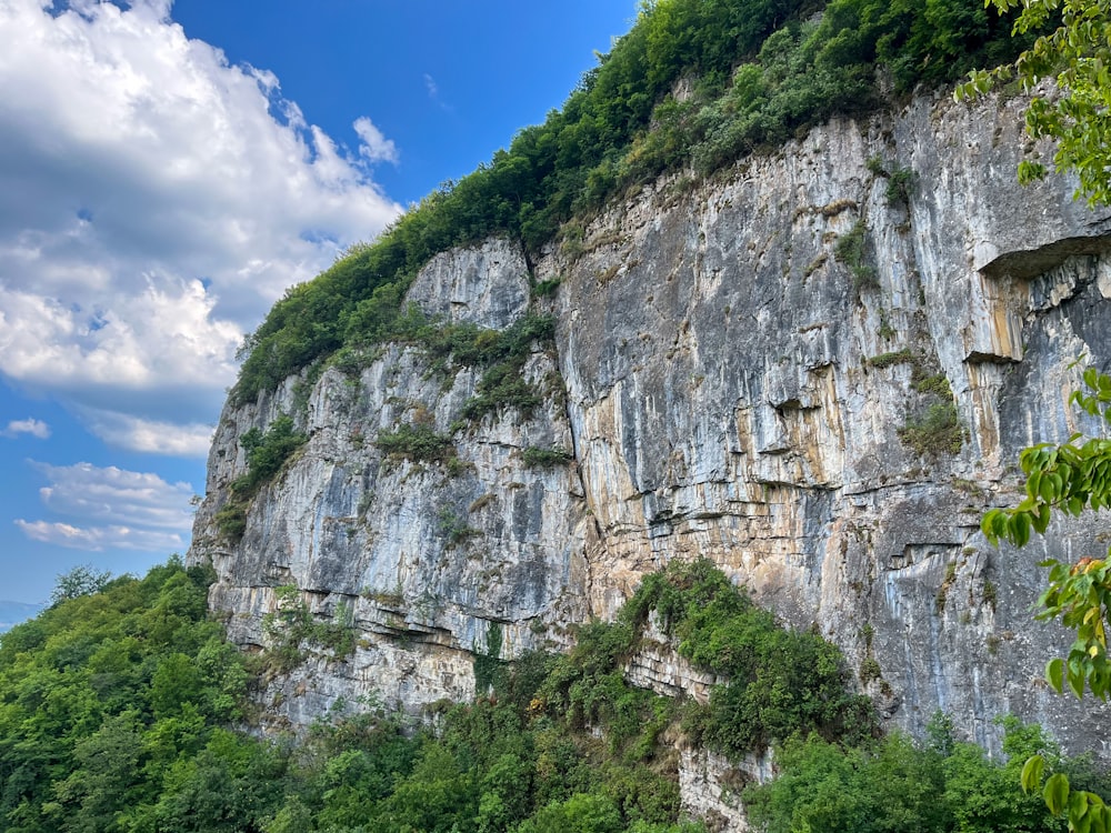 a mountain side with a very tall cliff