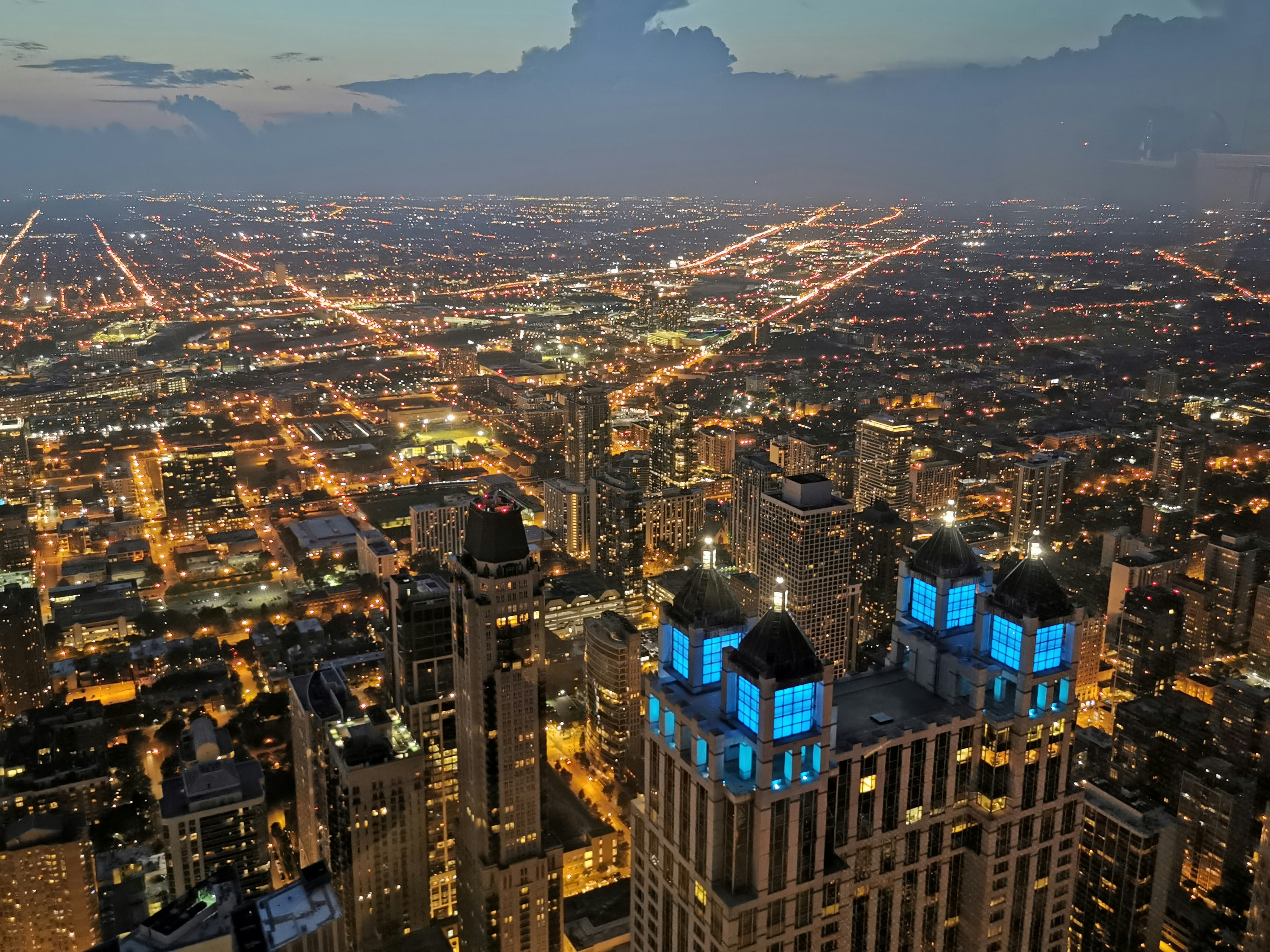 dramatic floor-to-ceiling windows showcasing a nighttime Chicago city view - city view