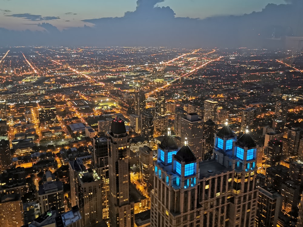 a view of a city at night from the top of a skyscraper