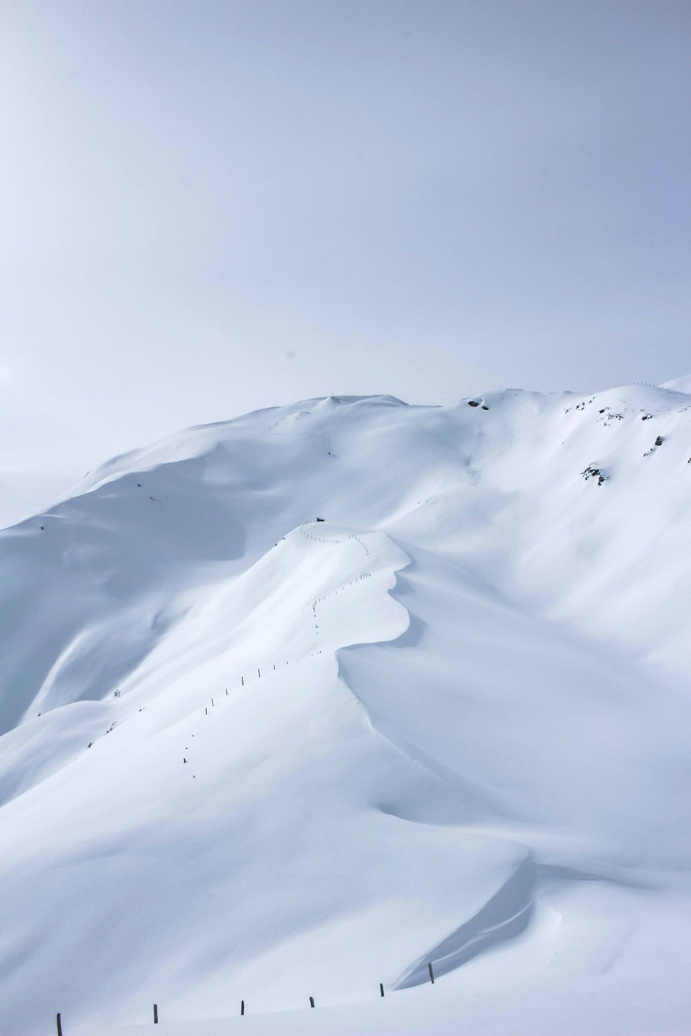 a person riding skis down a snow covered slope